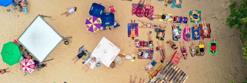 people lying on white sand